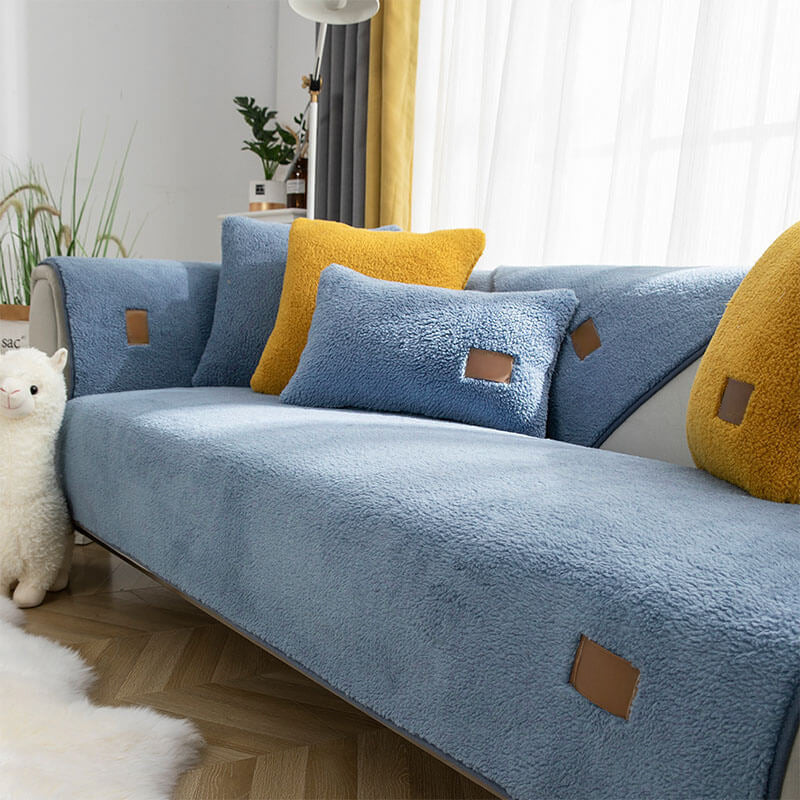 Blue sherpa-style sofa cover fitted to a two-seater sofa