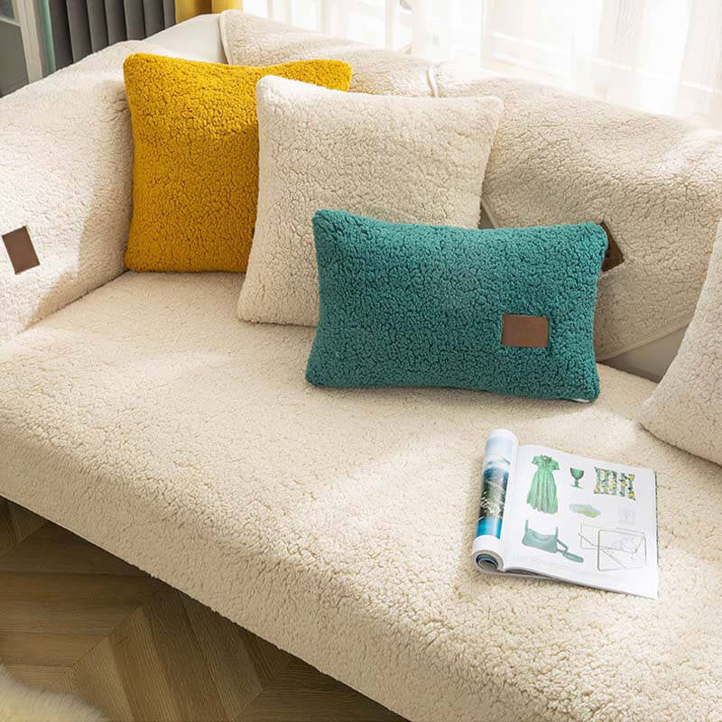 Cream sherpa-style sofa cover with green and yellow cushions