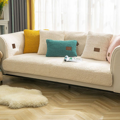Cream sherpa-style sofa cover fitted to a three-seater sofa