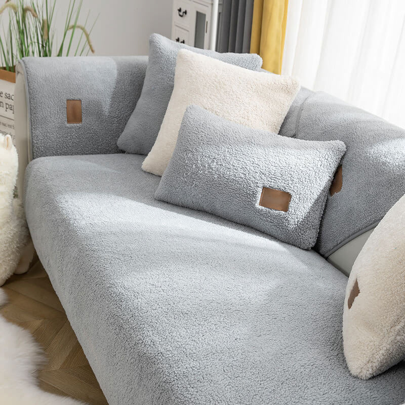 Grey sherpa-style sofa cover with matching cushions