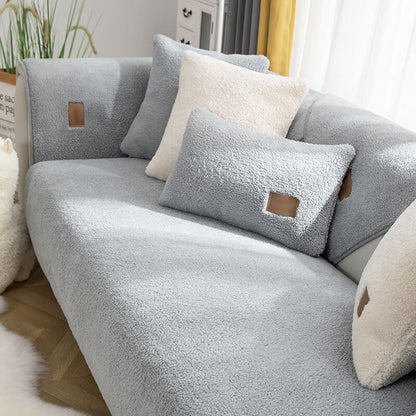 Grey sherpa-style sofa cover with matching cushions
