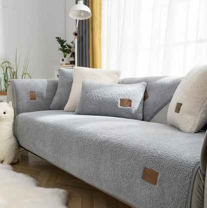 Grey sherpa-style sofa cover fitted to a two-seater sofa
