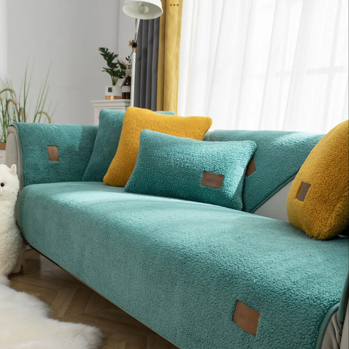 Spa green sherpa-style sofa cover fitted to a sofa