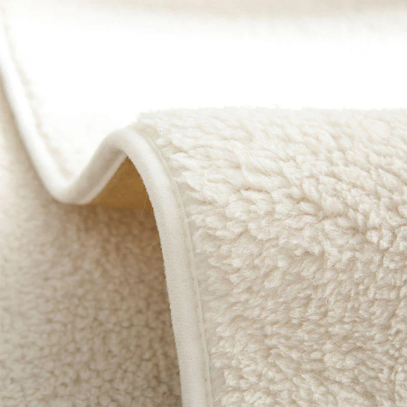Close-up of the cream sherpa-style fleece texture and edge
